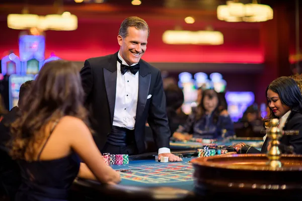 A close-up shot of golden coins falling around a spinning roulette wheel, representing immersive casino action at CAWABANGA.